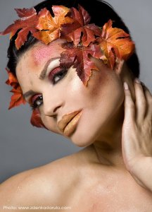pretty brunette woman wearing leaves and colorful makeup